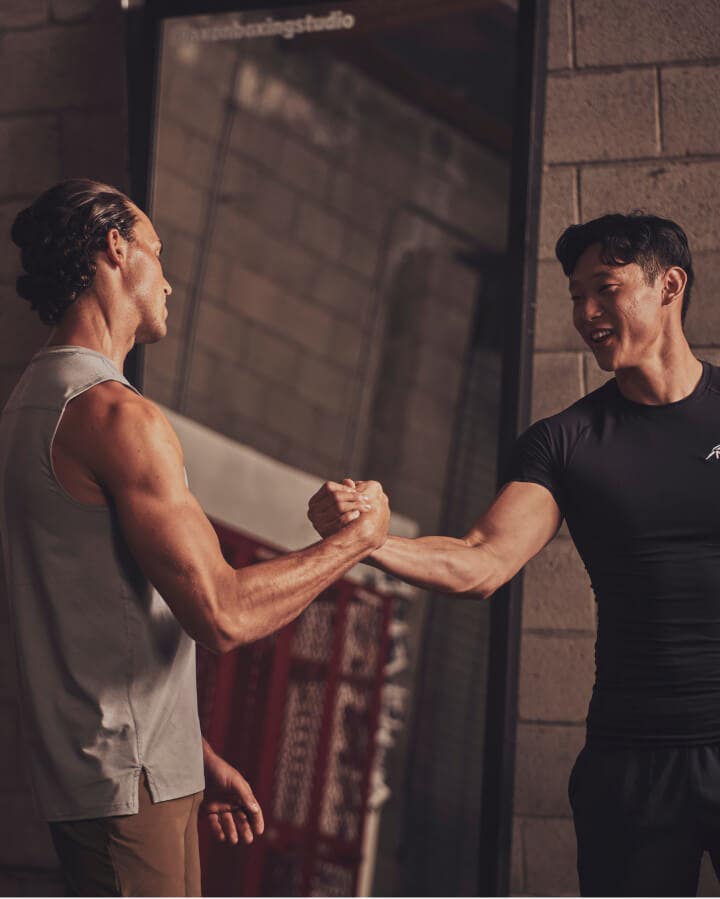 two male trainers shaking hands
