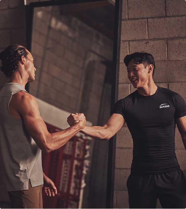 two male trainers shaking hands