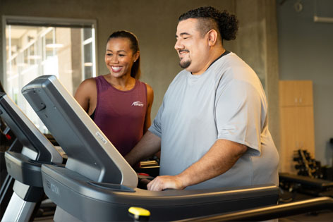 a trainer helping a woman lose weight