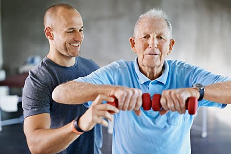 a senior fitness specialist helping an older client