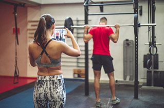 a trainer evaluating the squat form of a client