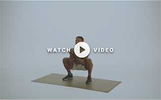 man squatting with kettlebell