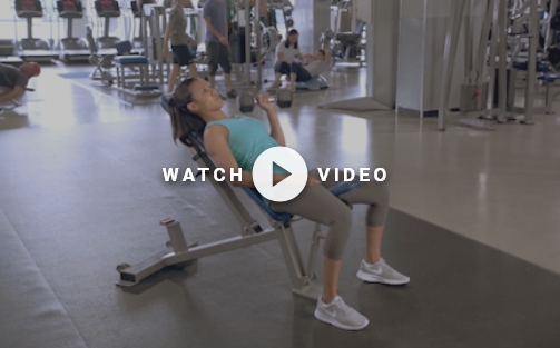 woman using weight bench