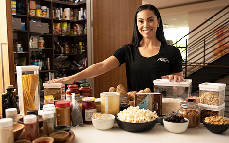 woman posing with food in kitchen