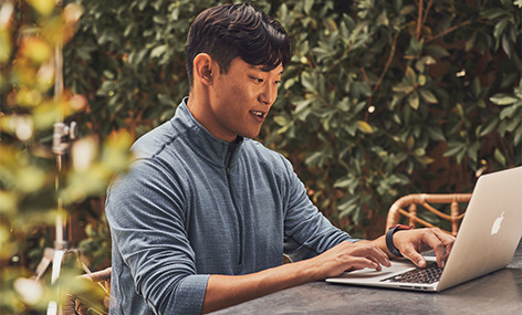 Man sitting outside on laptop