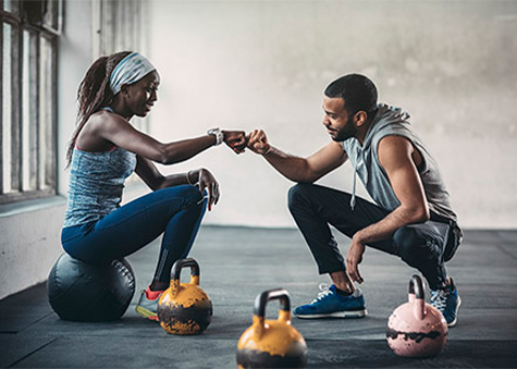 personal trainer and client fist bumping