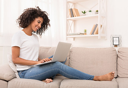 woman sitting and looking at laptop
