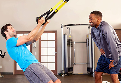 trainer and client using TRX bands