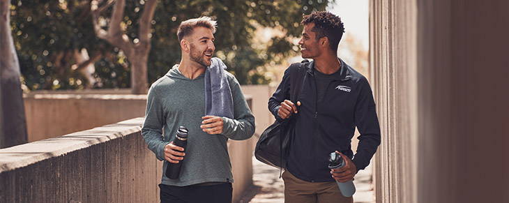 Male NASM Trainer walking with Male Client