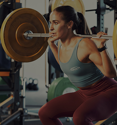 Woman squatting with weighted plates