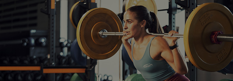 Woman squatting with weighted plates