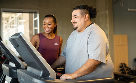NASM trainer assisting client on treadmill