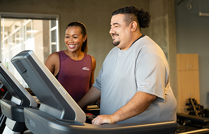 NASM Trainer assisting client on treadmill