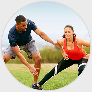 a trainer showing a client how to do a hip stretch