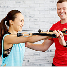 a master trainer teaching proper cable flys