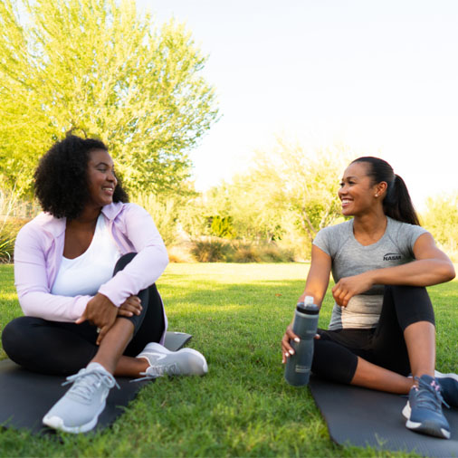 two women sitting down talking