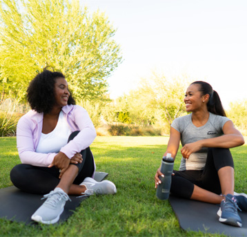 two women sitting down talking