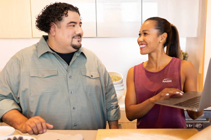 Female trainer with male client in the kitchen