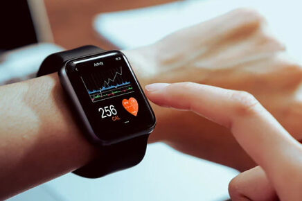 Female wearing apple watch showing heart rate and other anatomy data