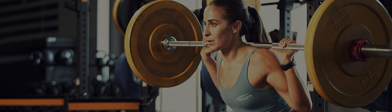 Woman squatting with weighted plates