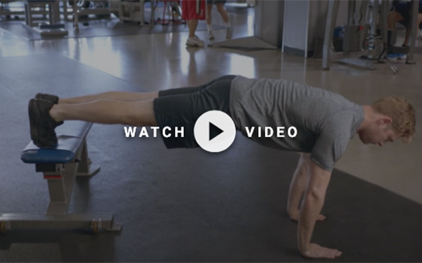 man performing a decline push up