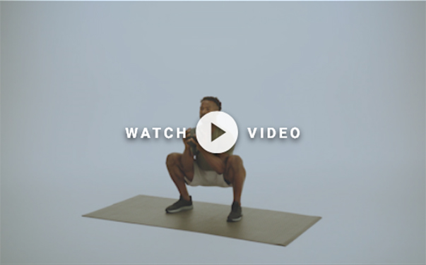 man squatting with kettlebell