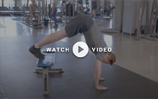 man performs pike push up