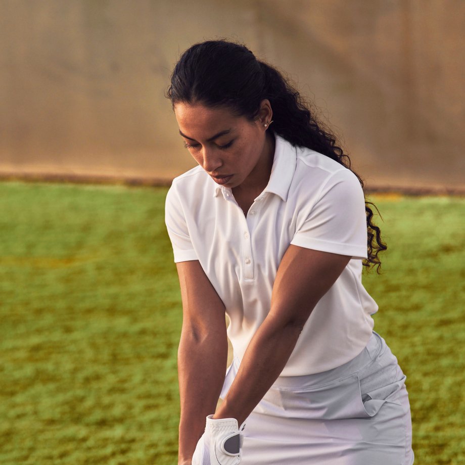 A woman swinging a golf club