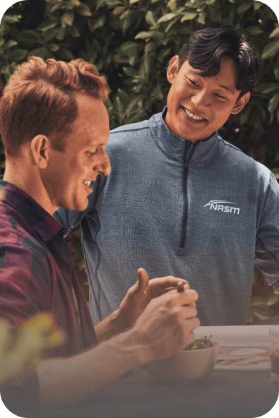 Two men making a salad