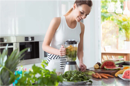 A woman making a healthy smoothie