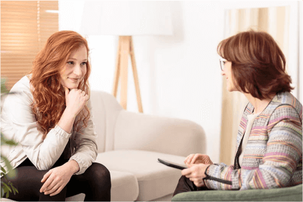 Two woman talking on the couch