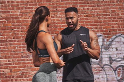 Andre Adams talking to female athlete