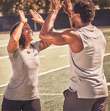 Female NASM trainer high fiving athlete