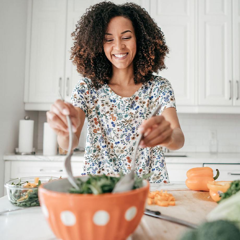 Female making salad in kitchen