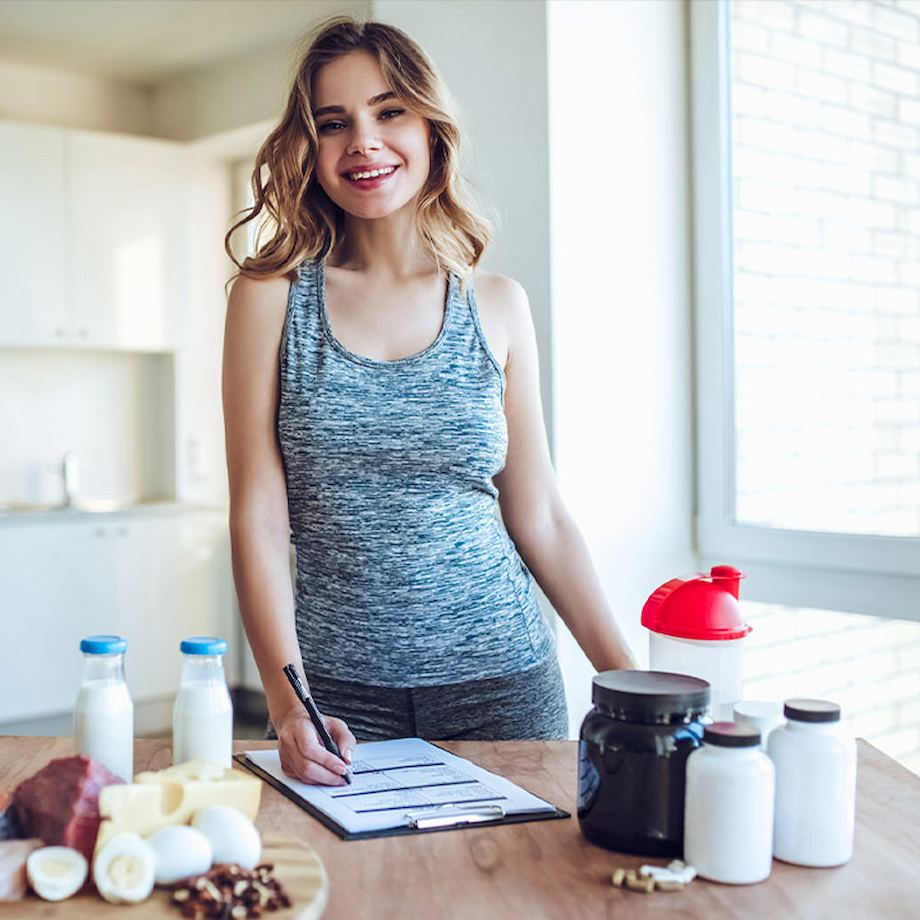 Female inside kitchen with handout and supplements and different foods