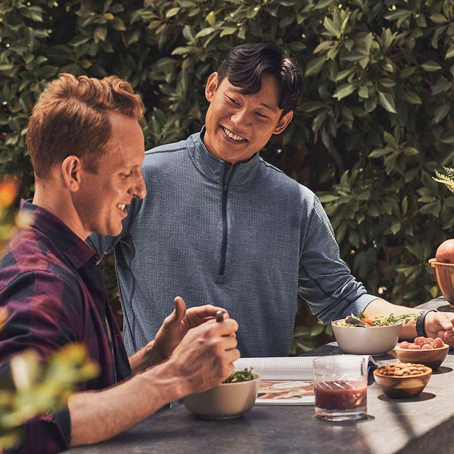 Two males talking outside about nutrition