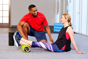 A corrective exercise specialist helping a client
