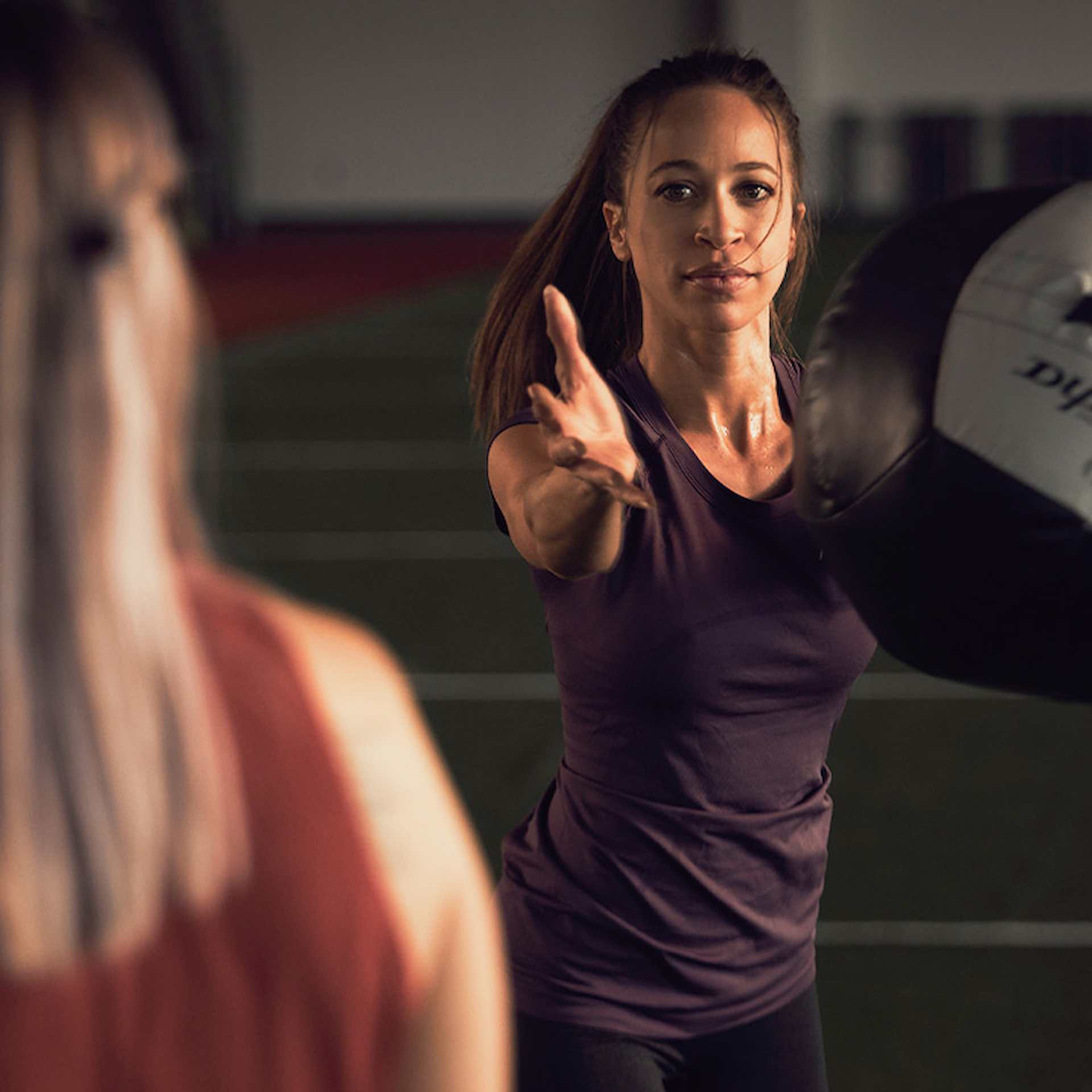 Female athlete doing a side weighted ball throw exercise