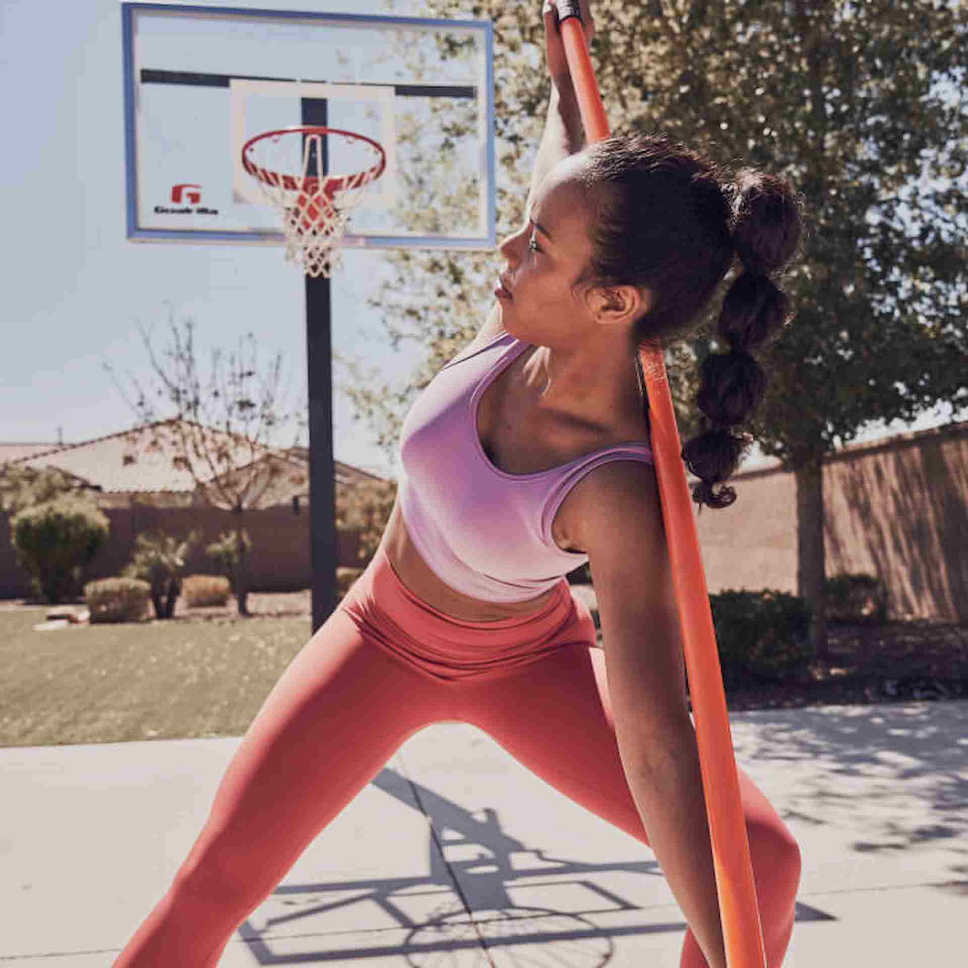 A woman stretching with a bar