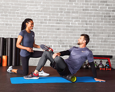 man and woman doing foam rolling exercises for stabilization training