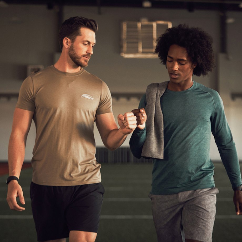 Male NASM trainer fist bumping the male athlete