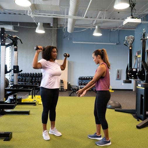 a woman fist bumping a man