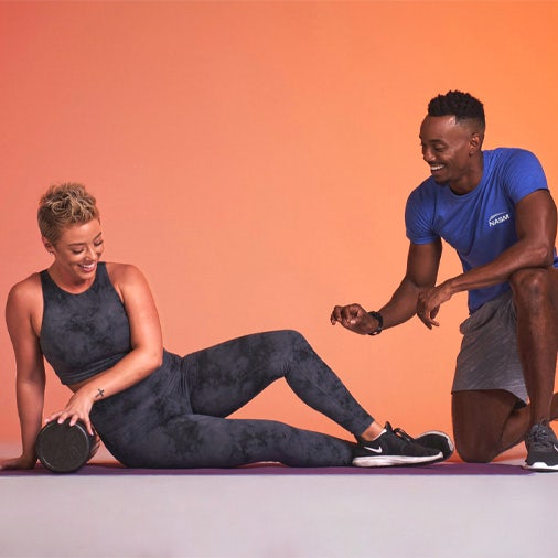 Woman doing a core workout man coaching