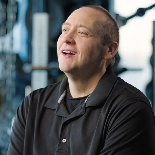 a man in black shirt being interviewed