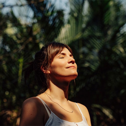 a women smiling in the sun