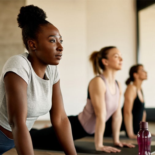Women doing yoga on a yoga mat