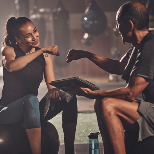 a woman fist bumping a man