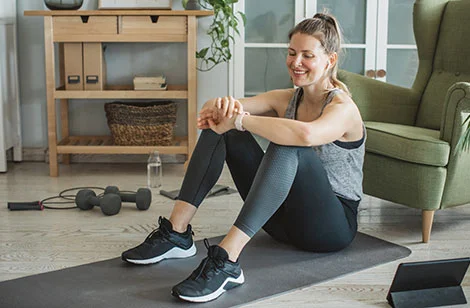 Lady sitting on yoga mat