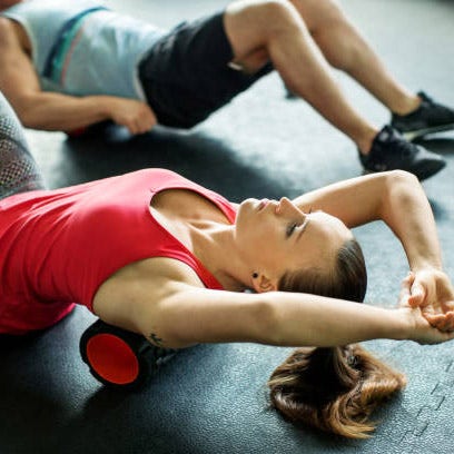 Two people foam rolling